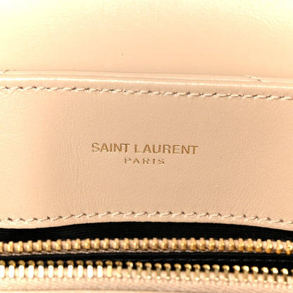 Dark beige leather satchel detail with stitched Saint Laurent Paris logo patch