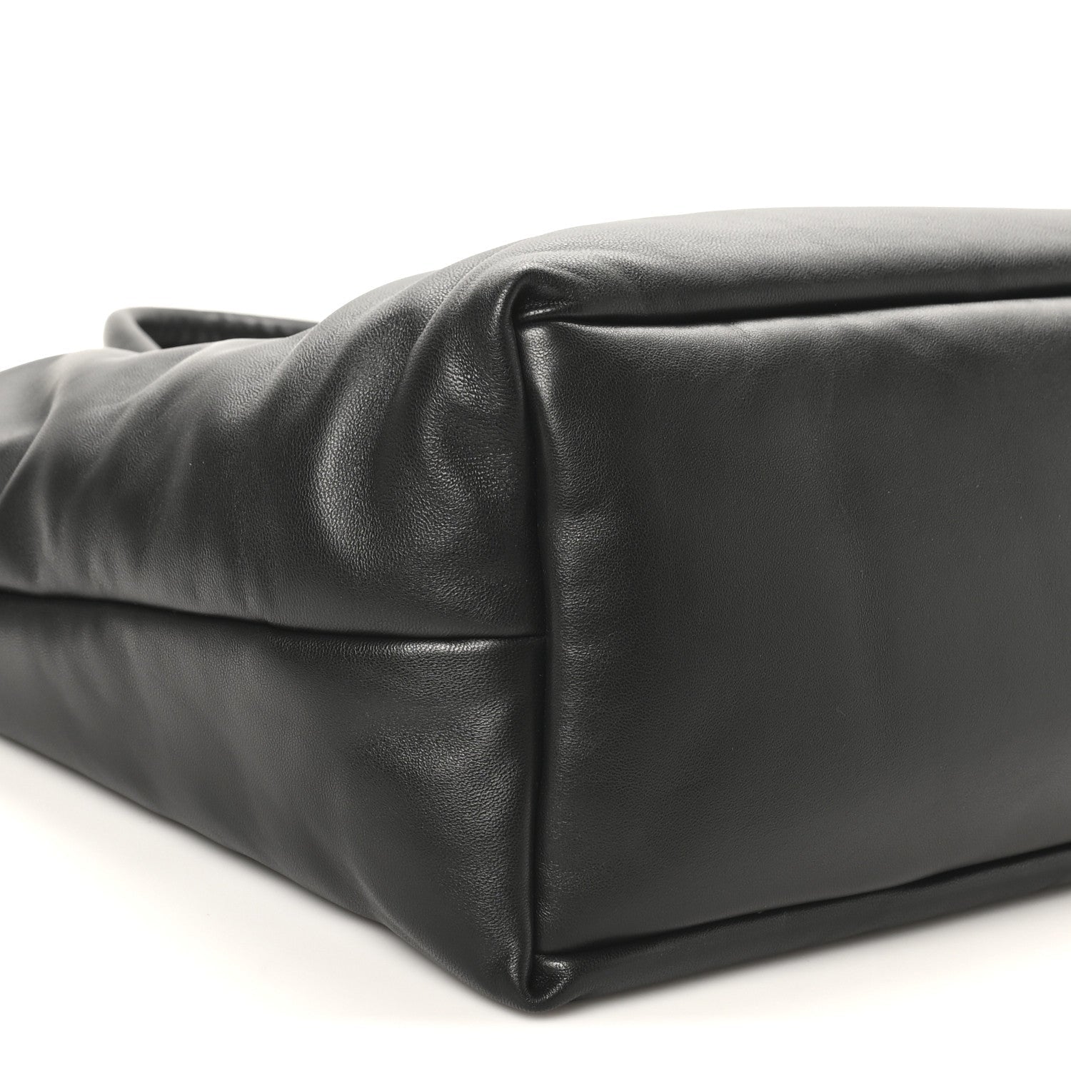 Black lambskin wide puffer tote with rounded bottom corner and puffer stitching.
