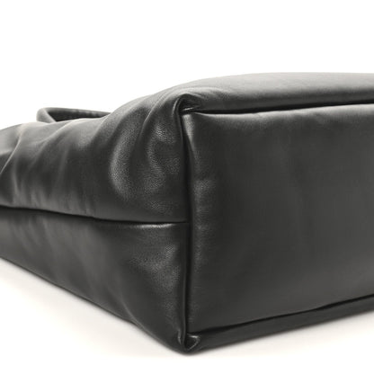 Black lambskin wide puffer tote with rounded bottom corner and puffer stitching.