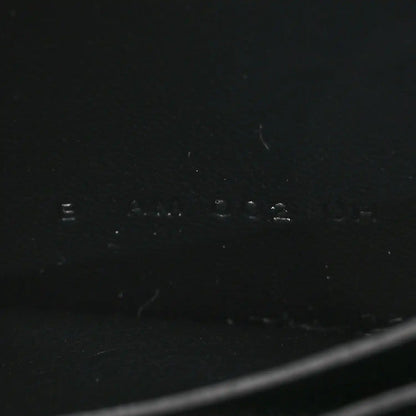 Black leather wallet exterior with faint stamped markings