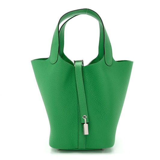 Green leather tote bag with top handles and center zipper lock