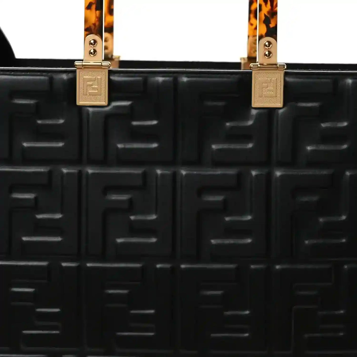 Black leather tote bag front with embossed FF pattern, top handle hardware
