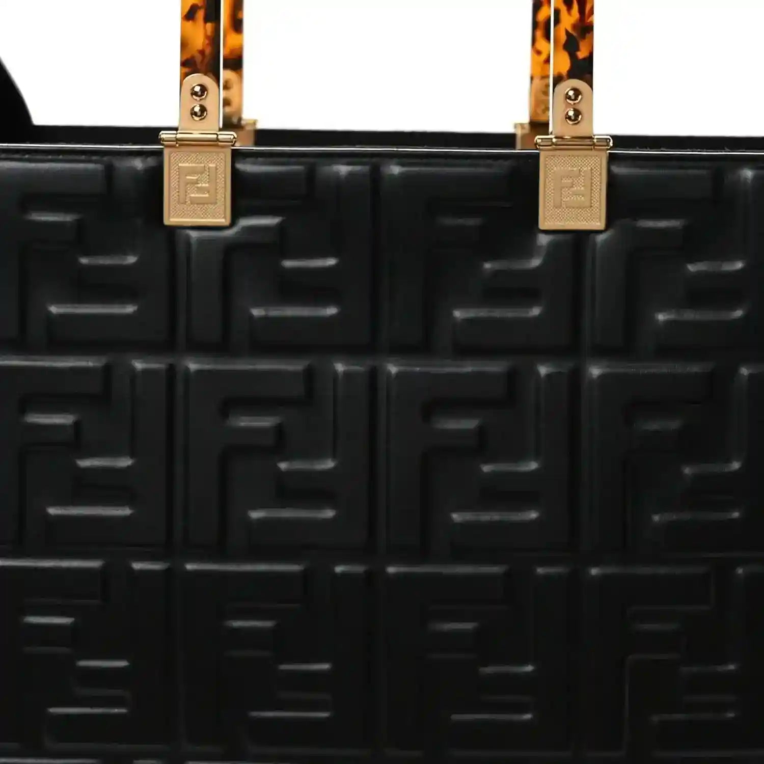 Black leather tote bag front with embossed FF pattern, top handle hardware