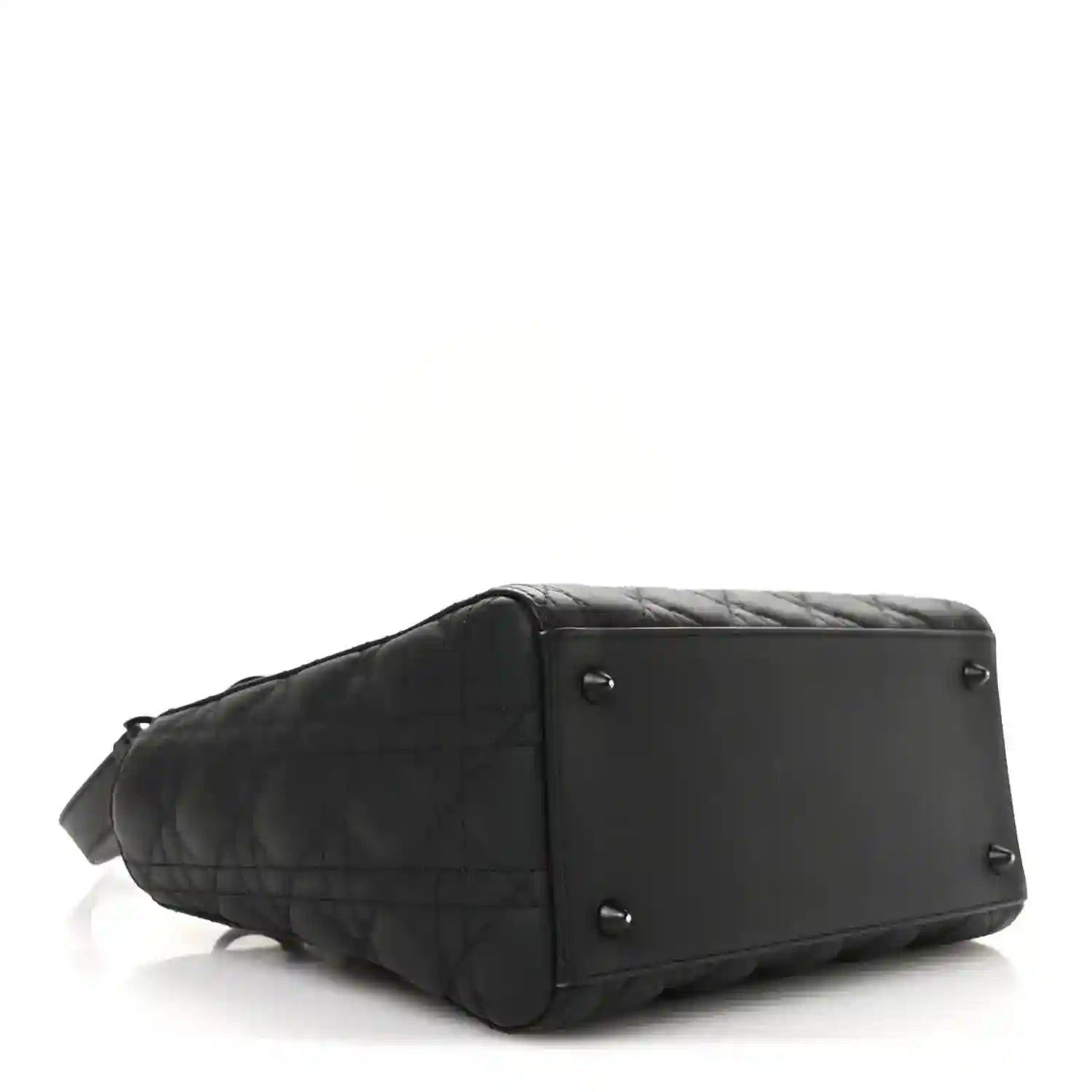 Black quilted Lady Dior bag with structured base and side panel hardware, profile view