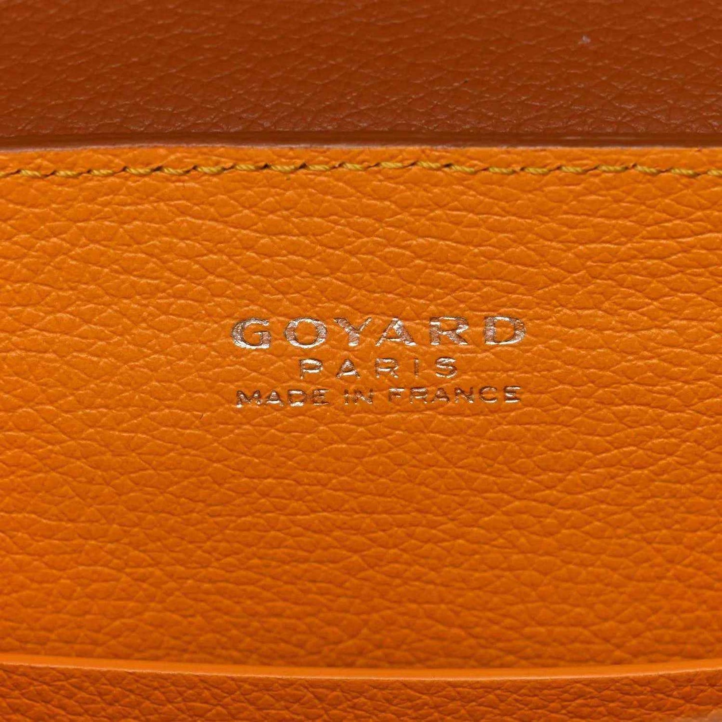 Goyard logo embossed on tan pebbled leather