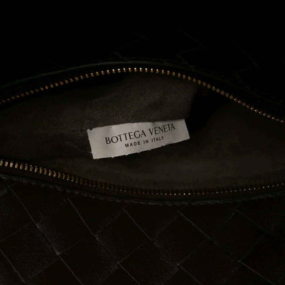 Small bucket bag interior with brand label, zipper track, and dark leather lining