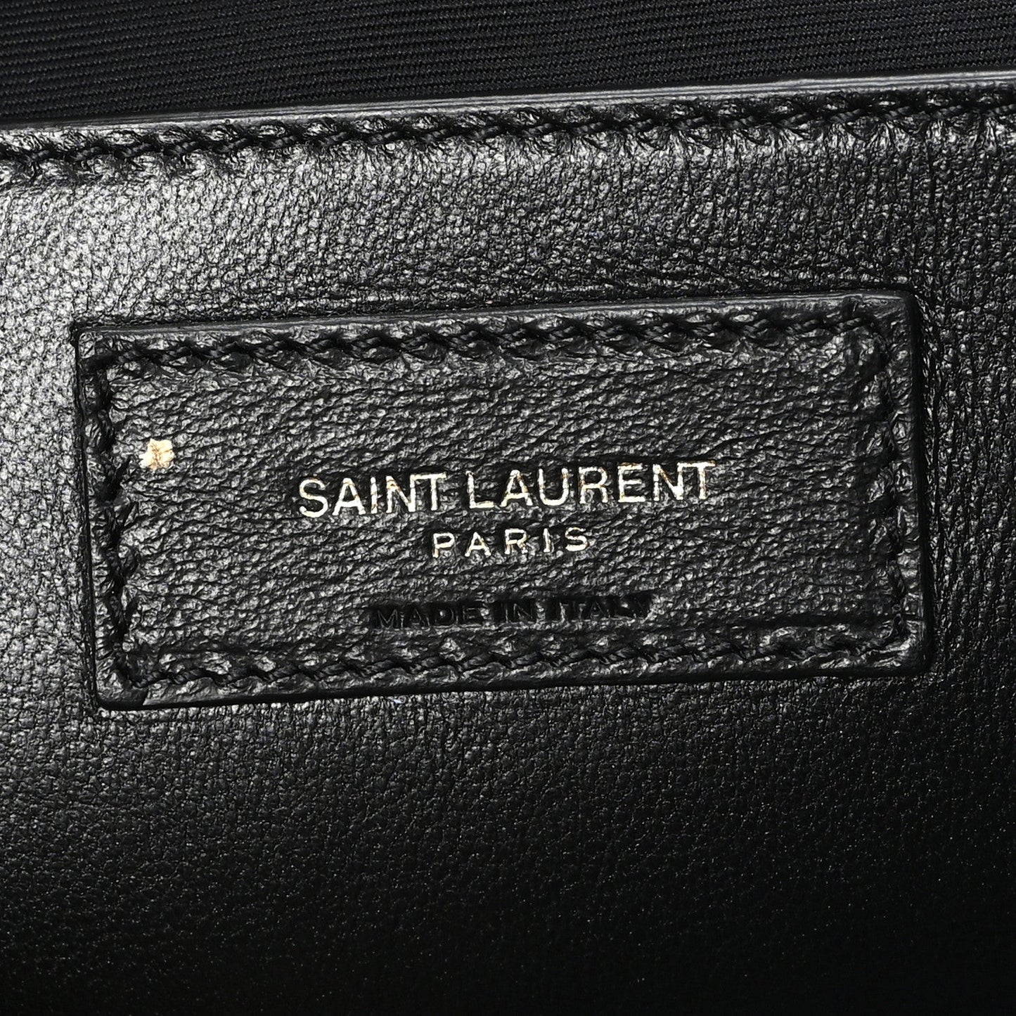 Leather brand tag inside shoulder bag reading SAINT LAURENT PARIS