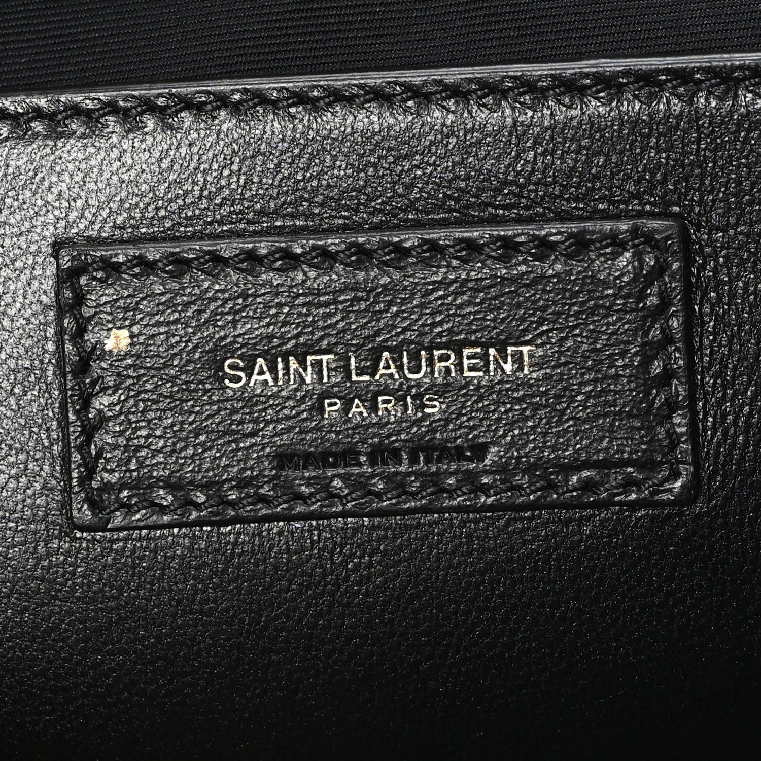 Leather brand tag inside shoulder bag reading SAINT LAURENT PARIS