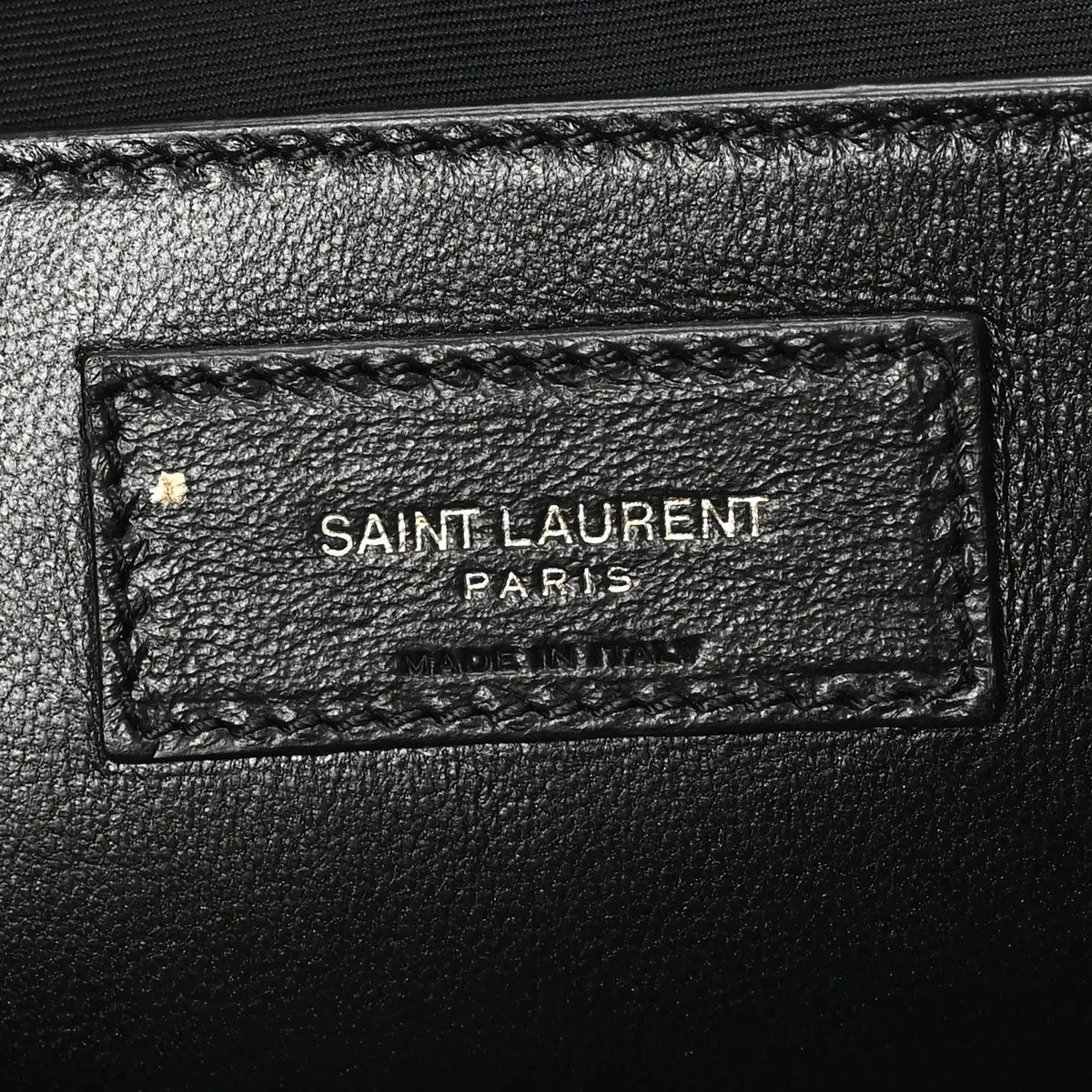 Leather brand tag inside shoulder bag reading SAINT LAURENT PARIS