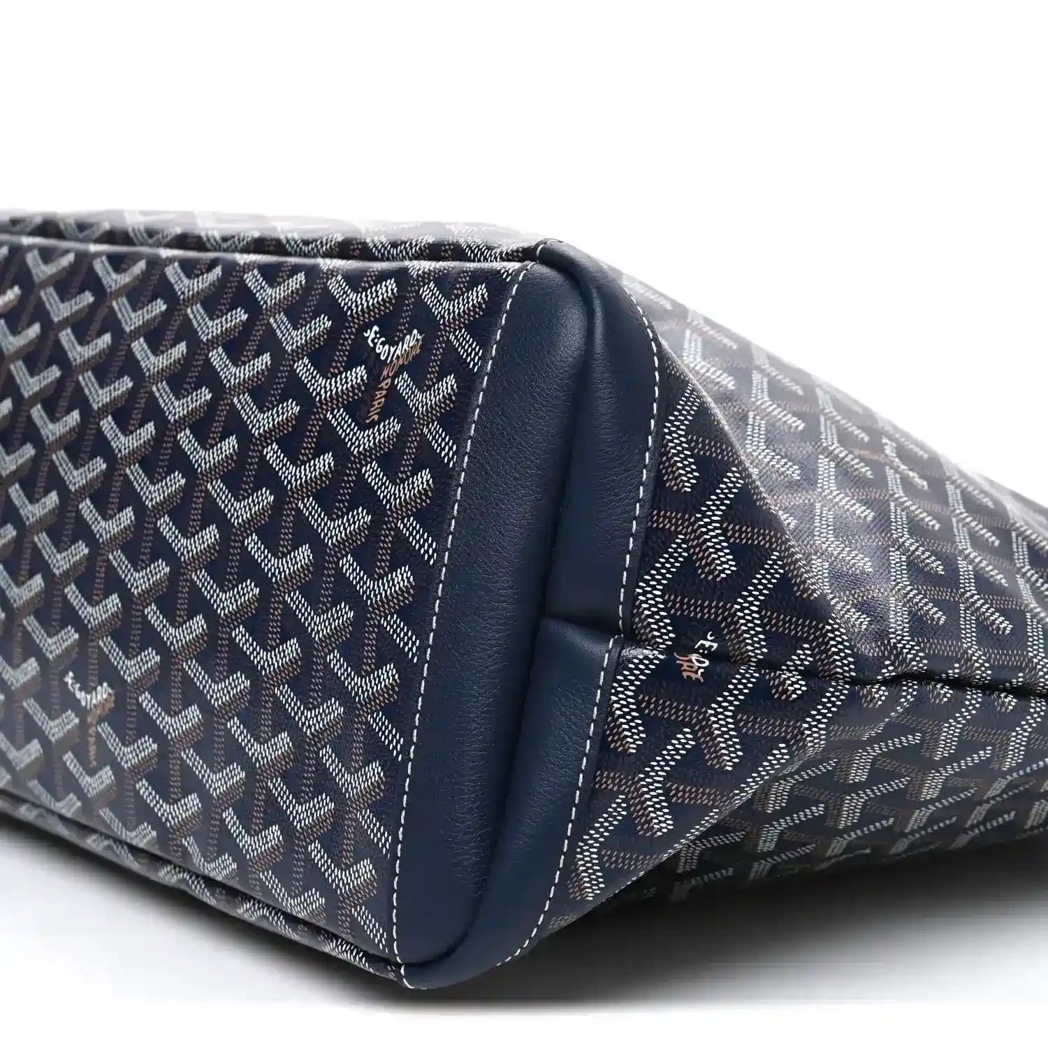 Navy tote bag bottom corner close-up with logo canvas and leather trim
