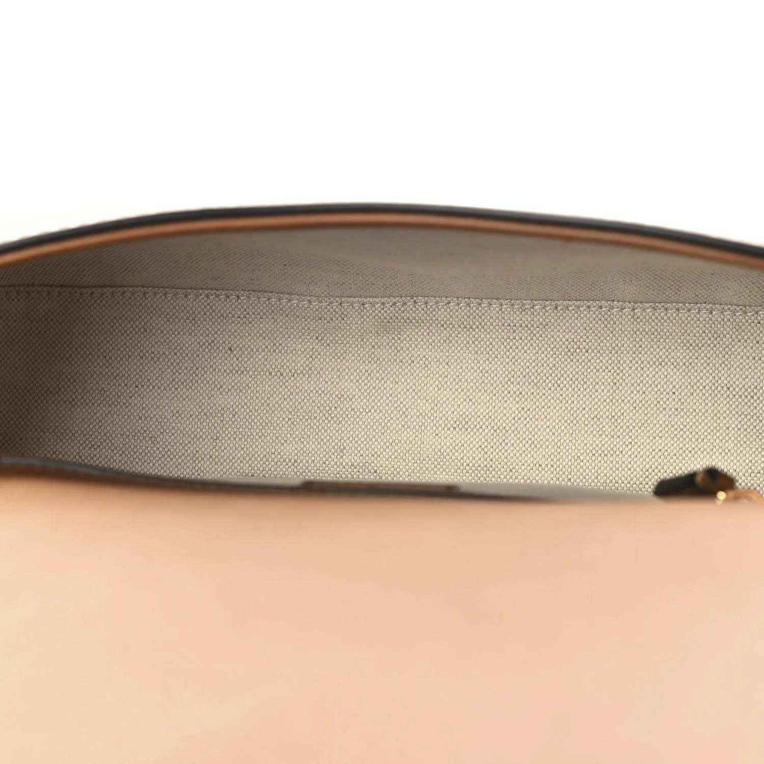 Beige canvas interior lining with brown leather top edge on a medium bag