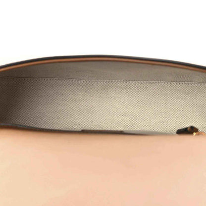 Beige canvas interior lining with brown leather top edge on a medium bag