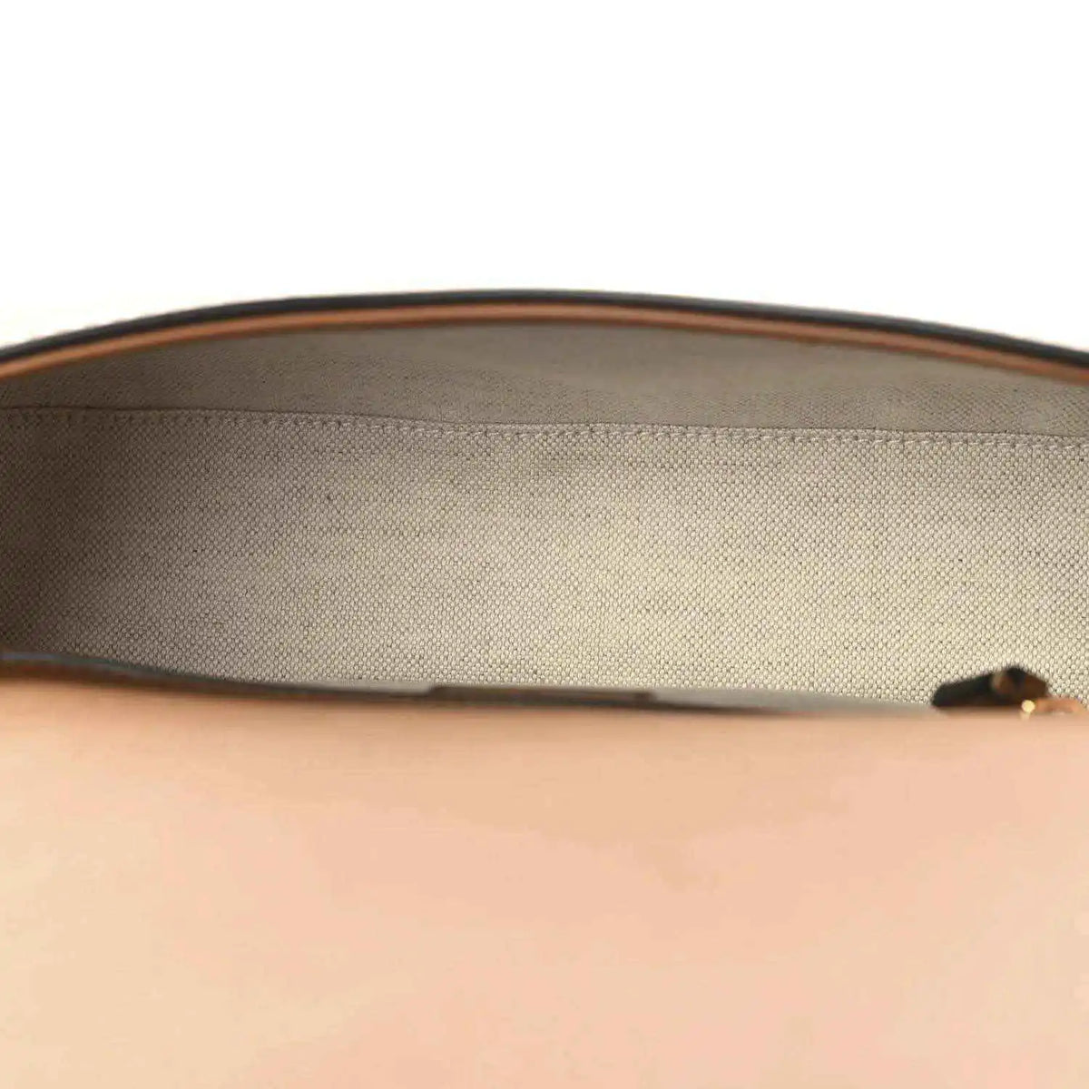 Beige canvas interior lining with brown leather top edge on a medium bag