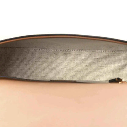 Beige canvas interior lining with brown leather top edge on a medium bag