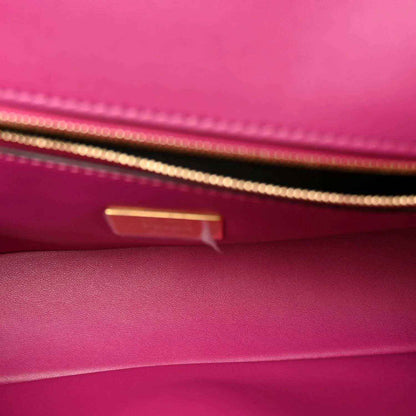 Pink leather baguette interior with gold-tone hardware and visible stitching