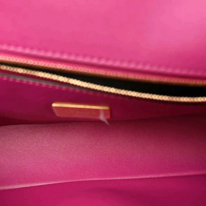 Pink leather baguette interior with gold-tone hardware and visible stitching