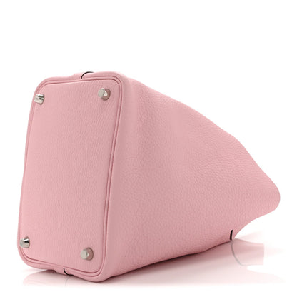Mauve textured leather handbag back view with corner hardware and metal feet
