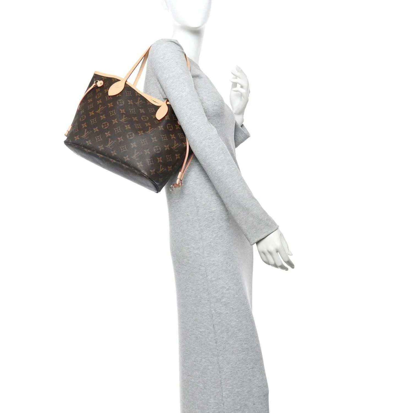 Monogram canvas mini tote bag with tan leather straps and gold hardware, worn on model