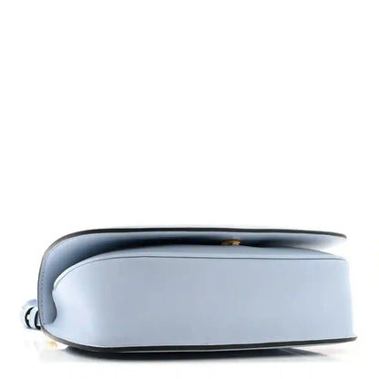 Light blue Gucci medium top-handle bag shown from the side with rounded base