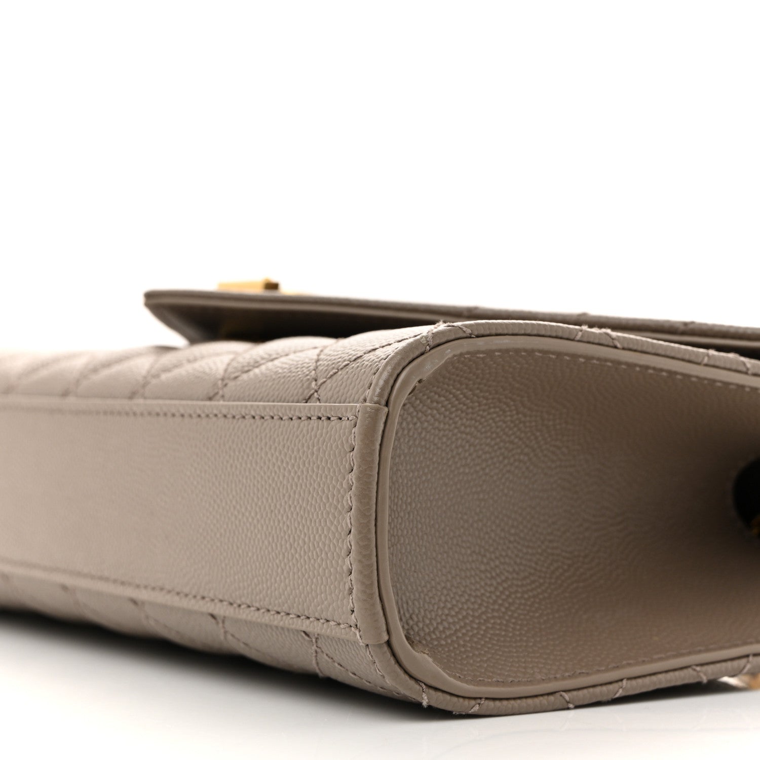 Textured satchel side panel with rounded edge and stitching