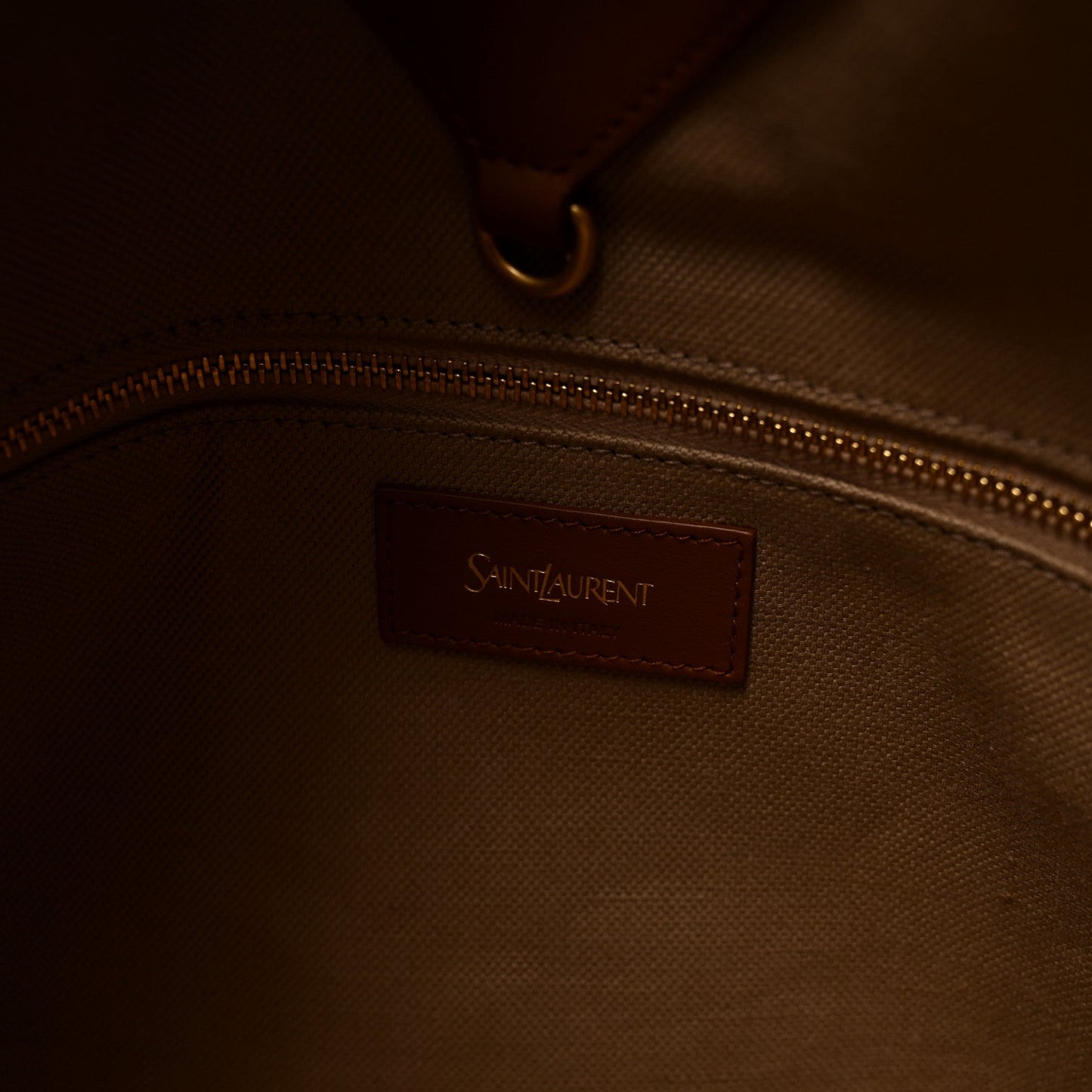 Inside pocket of tan Y tote with Saint Laurent leather patch and zipper pull