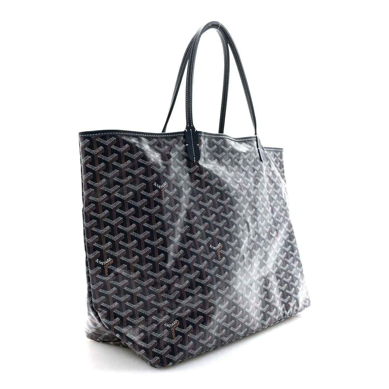 Navy Goyardine tote bag with leather handles and repeating Goyard logo pattern.