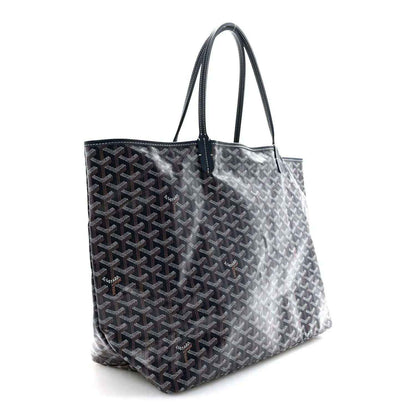 Navy Goyardine tote bag with leather handles and repeating Goyard logo pattern.