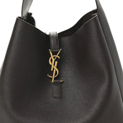 Top closure with gold YSL logo charm on dark leather hobo bag