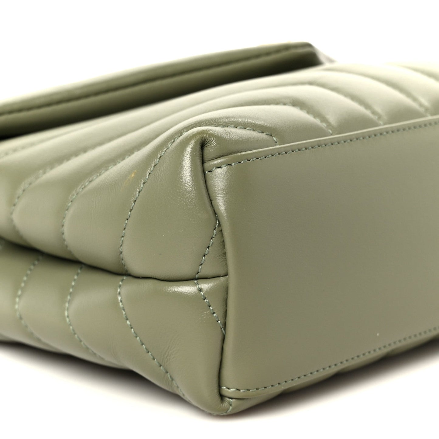 Light sage quilted leather corner detail with stitched edge on small satchel