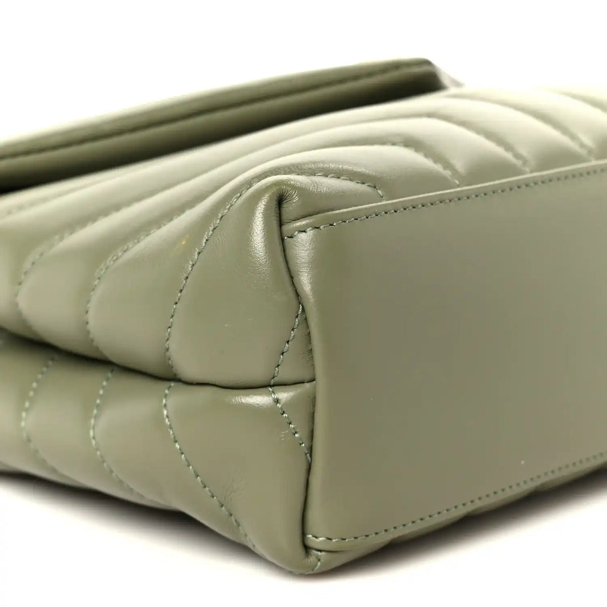 Light sage quilted leather corner detail with stitched edge on small satchel
