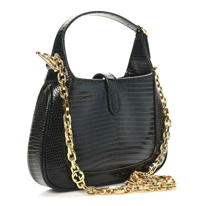 Gucci black lizard mini Jackie handbag with front flap and gold-tone chain crossbody strap.