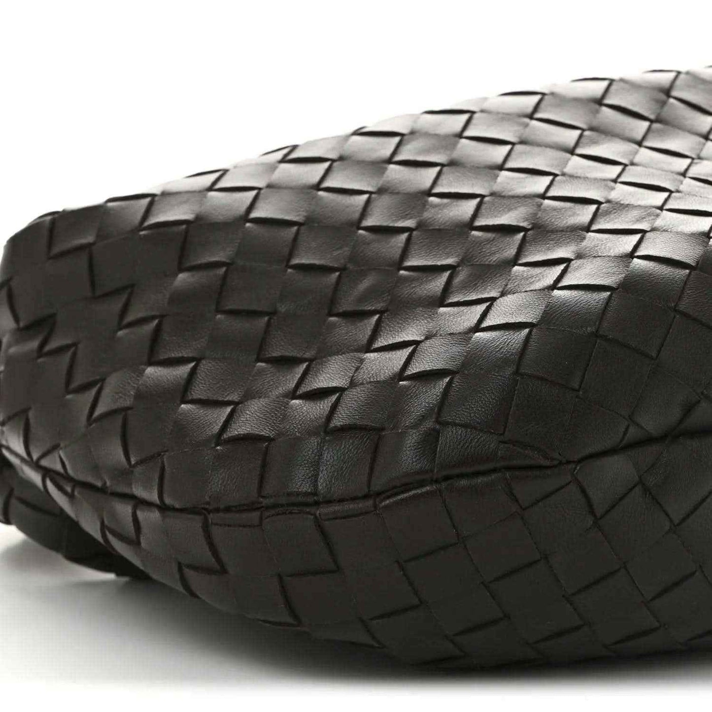 Rounded side of dark intrecciato hobo bag with woven leather texture