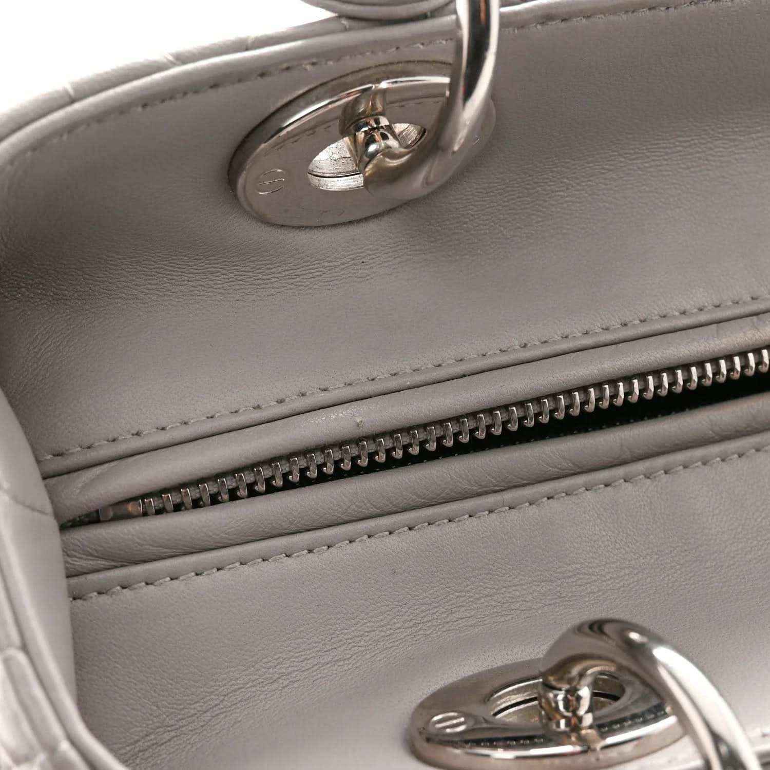 Grey leather handbag with interior zipper trim and silver hardware