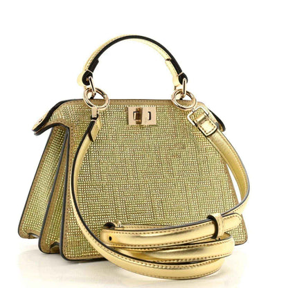 Gold crystal satchel with top handle, front clasp, and crossbody strap with buckle