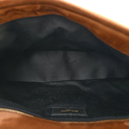 Saint Laurent suede shoulder bag interior with dark fabric lining and top zipper.