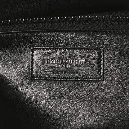 Black leather tote interior label with SAINT LAURENT PARIS branding and stitching.