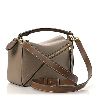 Small Puzzle bag front with zip pocket, crossbody strap, sand leather with dark trim