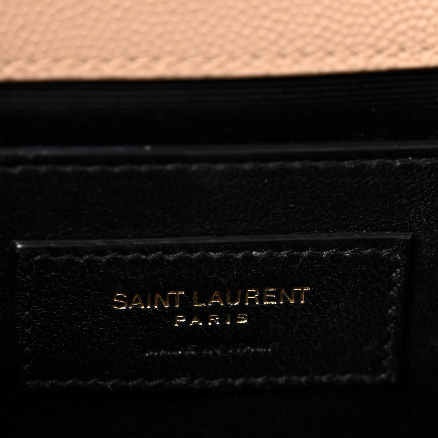 Saint Laurent Paris logo patch on black leather satchel panel