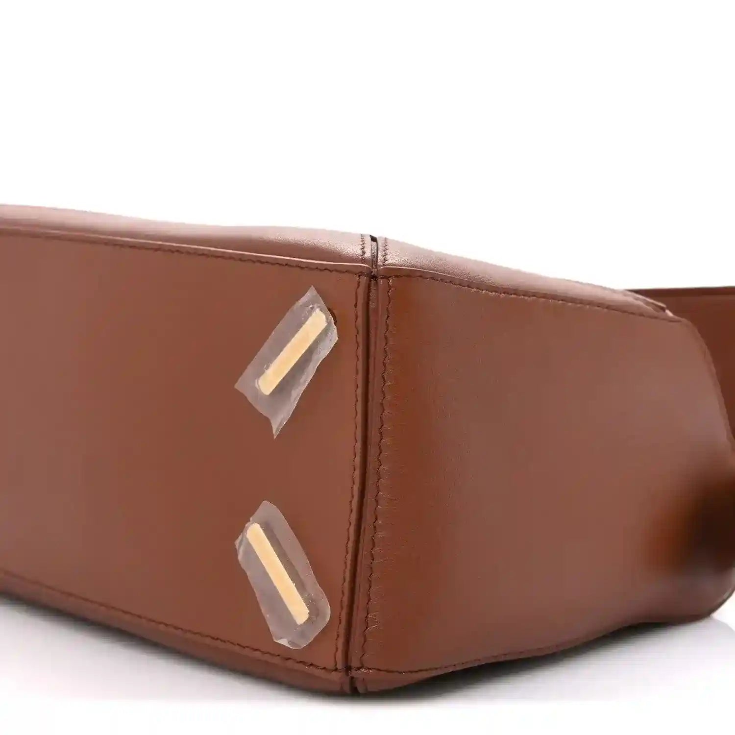 Small Puzzle bag side close-up with gold-tone hardware and top edge stitching