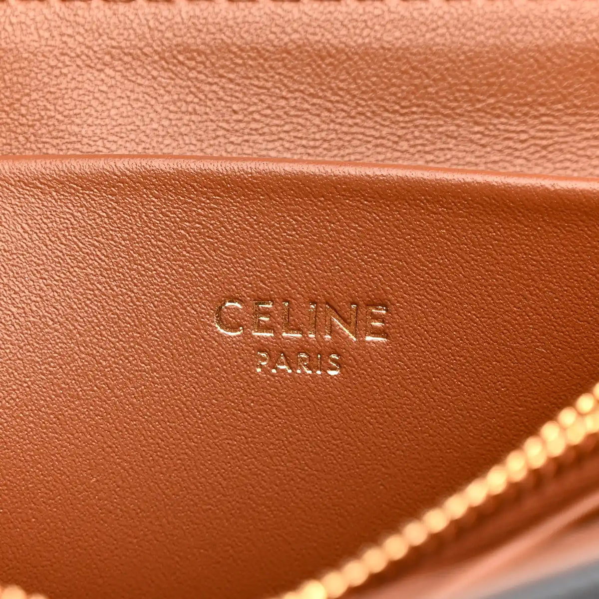 Celine Triomphe shoulder bag close-up of tan interior leather with “CELINE PARIS” stamp