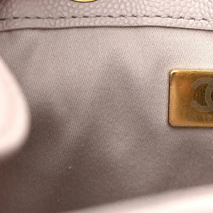 Gold serial plate on lilac fabric lining near an interior label area