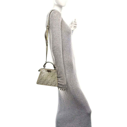 Petite Peekaboo satchel worn crossbody, small olive patterned bag on a thin strap