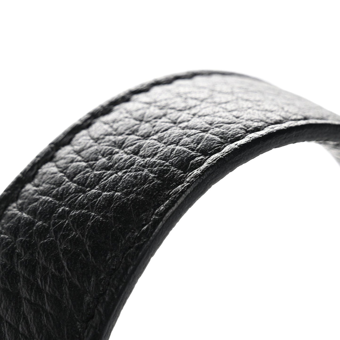 Black pebbled leather tote handle close-up with curved edge