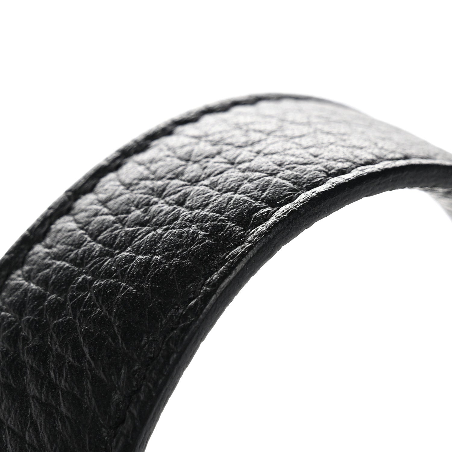 Black pebbled leather tote handle close-up with curved edge