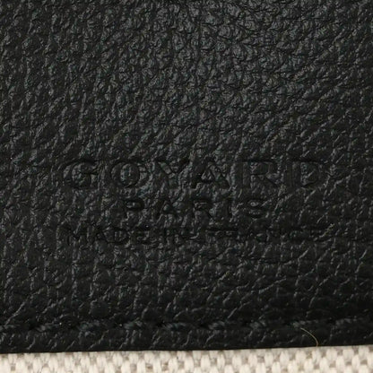 Black leather patch detail with embossed brand text on shoulder bag