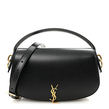 Black box-calf Voltaire top-handle crossbody bag with gold YSL logo clasp.