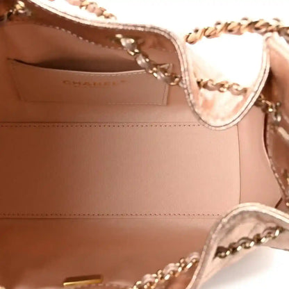 Copper quilted mini handbag interior view with stitched lining and chain hardware.