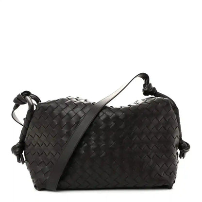Black woven leather weekender bag with loop handles and knotted side cords