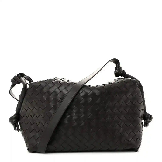 Black woven leather weekender bag with loop handles and knotted side cords
