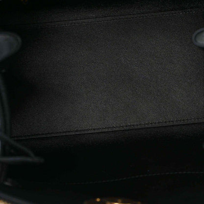 Black fabric lining inside a small leather handbag